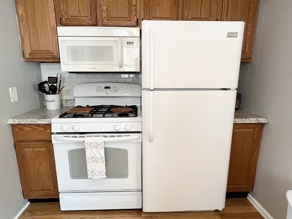 135 Balsam Street Fairhaven, MA 02719 - Photo 16 of 39 a stove top oven sitting inside of a kitchen