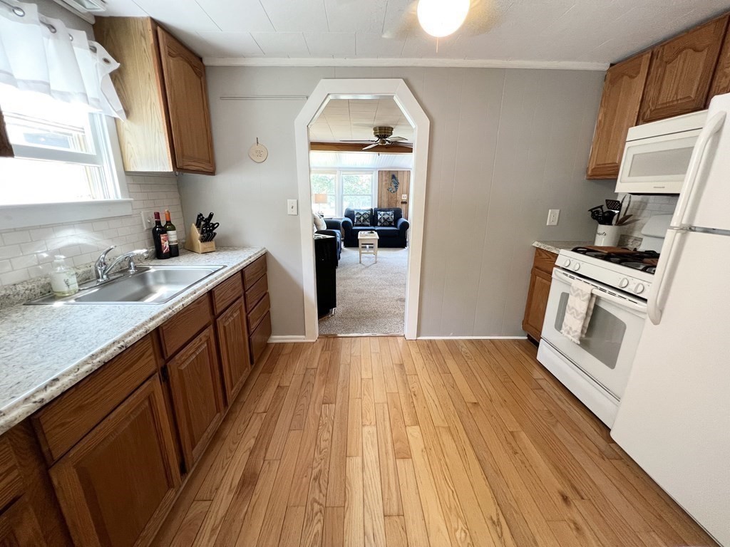 135 Balsam Street Fairhaven, MA 02719 - Photo 17 of 39 a kitchen with a sink and wooden floor
