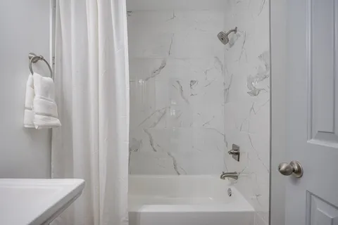 a bathroom with a shower curtain and a sink