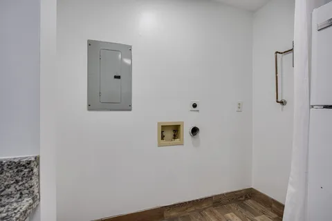 a view of a room with wooden floor and cabinet