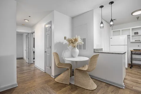 a dining room with furniture and wooden floor