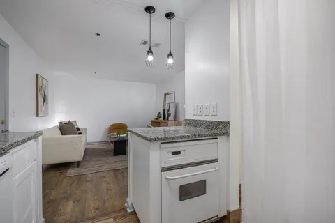 a kitchen with stainless steel appliances granite countertop a stove and a sink