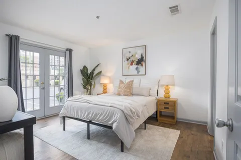 a bedroom with a large bed and a window