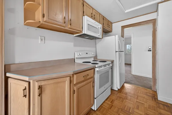 a kitchen with stainless steel appliances granite countertop a refrigerator and a stove