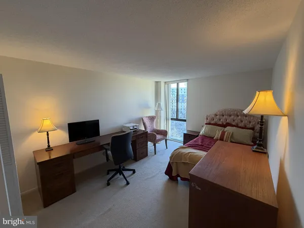 a bedroom with a bed and a lamp