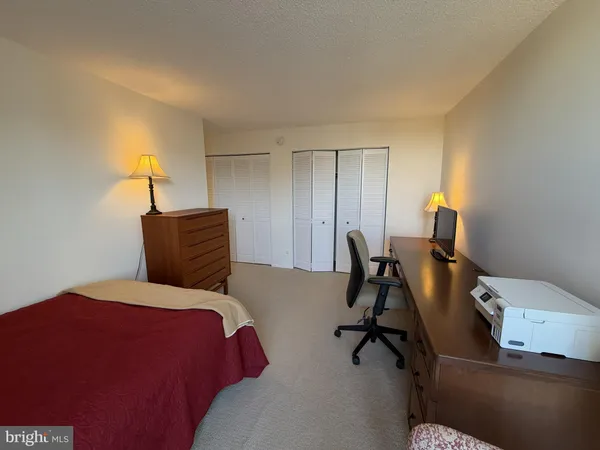 a bedroom with a bed and a desk