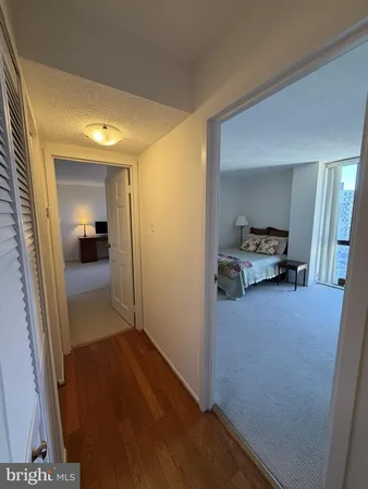 a view of a hallway and a livingroom with furniture