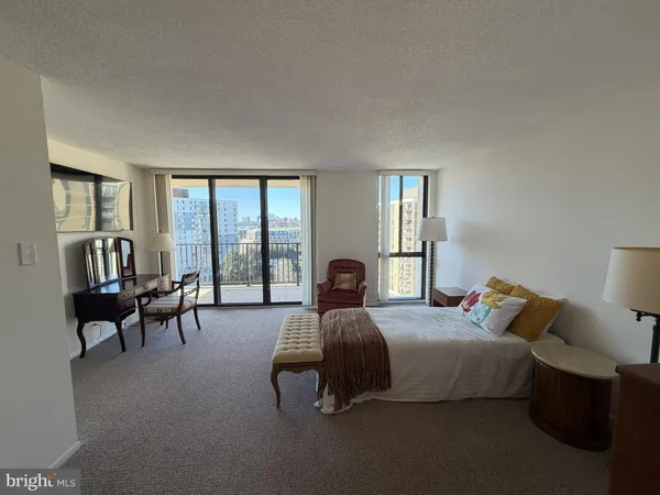 a bedroom with a bed and a large window