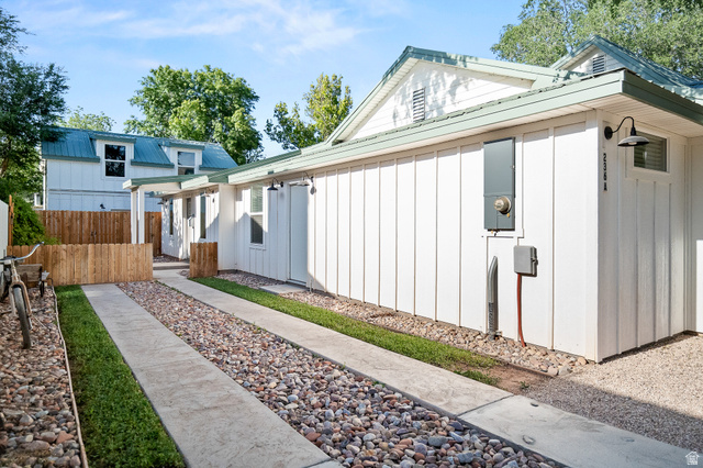 236 West 300 South Hurricane, UT 84737 - Photo 57 of 76 Modern exterior featuring board and batten siding, a metal roof, and gooseneck barn lighting