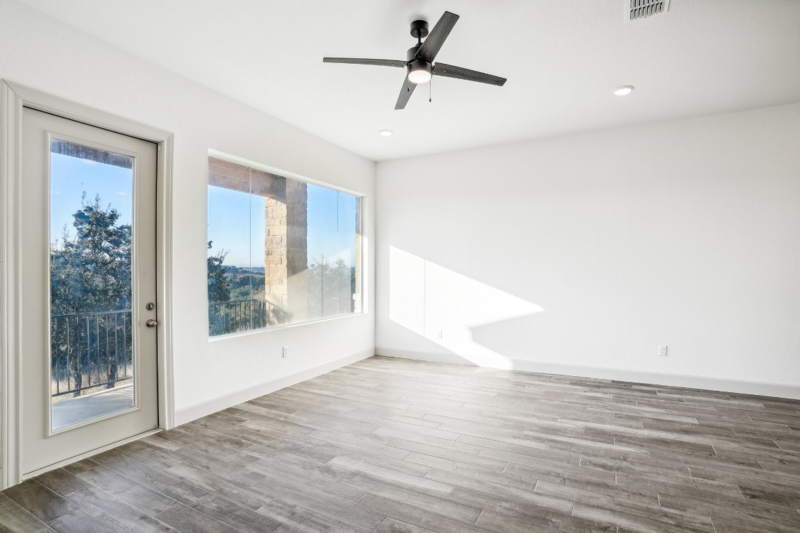 289 Star Grass Spring Branch, TX 78070 - Photo 12 of 39 a view of empty room with wooden floor and fan