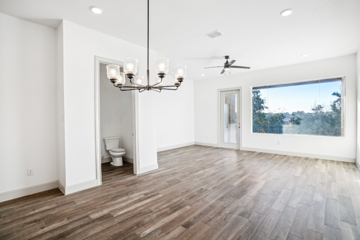 289 Star Grass Spring Branch, TX 78070 - Photo 14 of 39 a view of a room with wooden floor and a ceiling fan