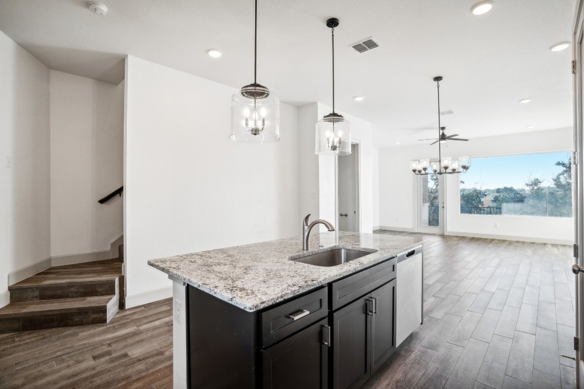 289 Star Grass Spring Branch, TX 78070 - Photo 17 of 39 a kitchen with kitchen island white cabinets and refrigerator