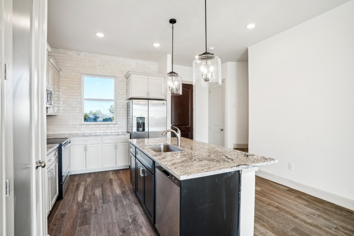 289 Star Grass Spring Branch, TX 78070 - Photo 18 of 39 a kitchen with a sink stove and refrigerator
