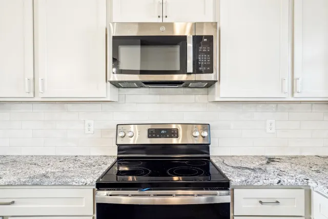 a stove top oven sitting inside of a kitchen