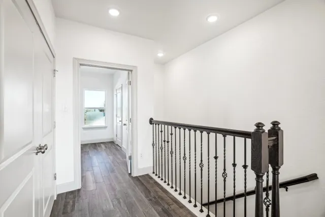 a view of a hallway with a hardwood floor