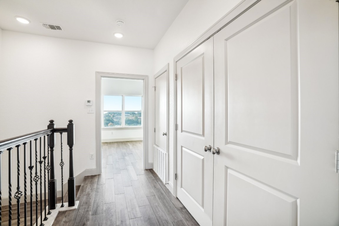 289 Star Grass Spring Branch, TX 78070 - Photo 22 of 39 a view of a hallway with wooden floor and a bathroom