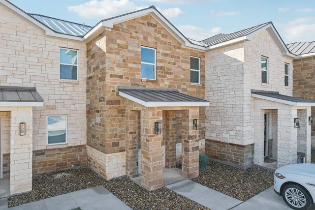 a view of a brick house with windows