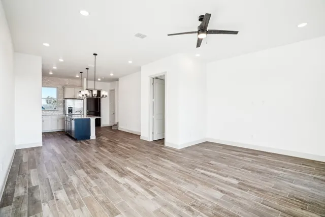 a view of a kitchen with a sink and a refrigerator