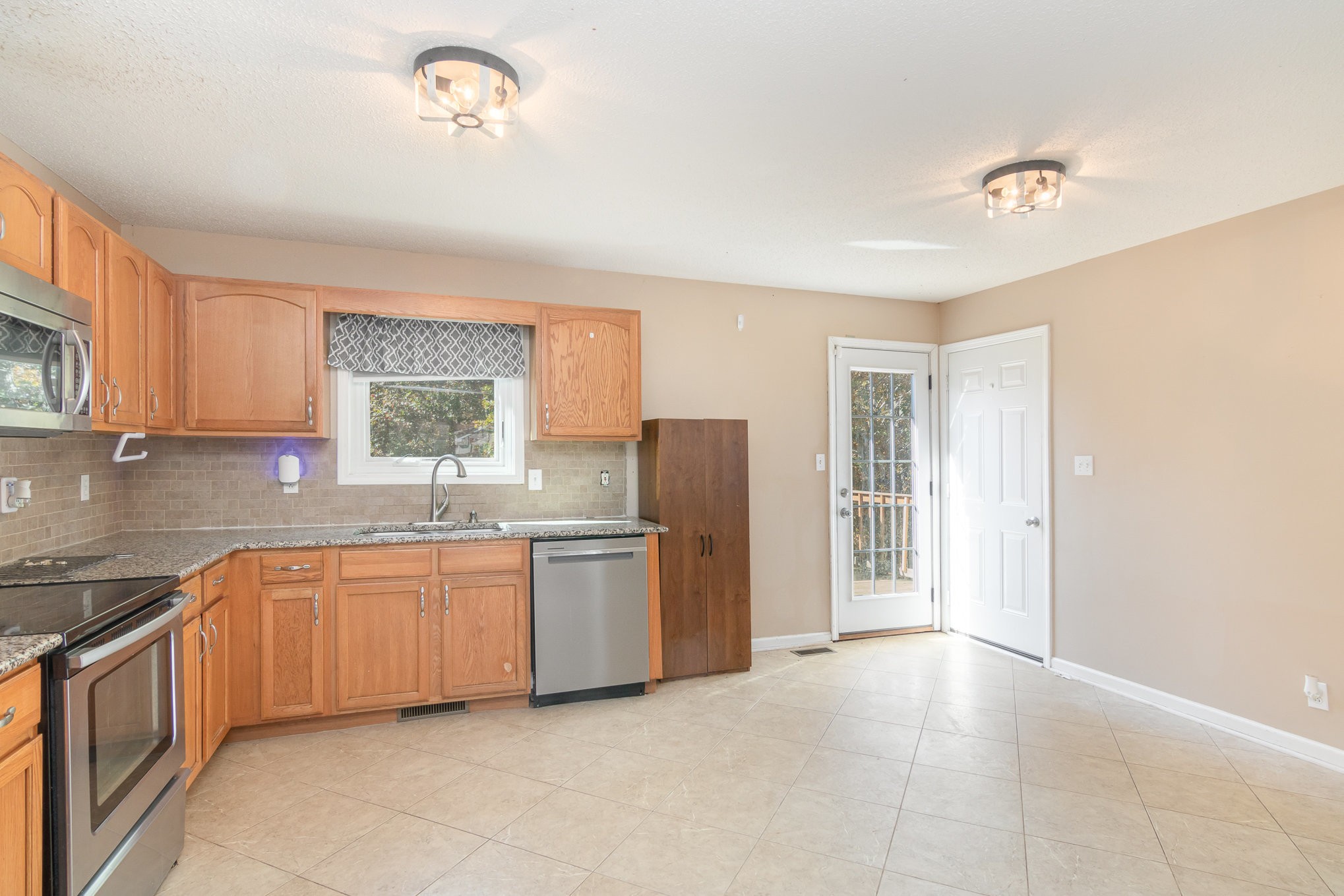 3289 Backridge Road Woodlawn, TN 37191 - Photo 11 of 30 a view of a kitchen with sink dishwasher and wooden floor