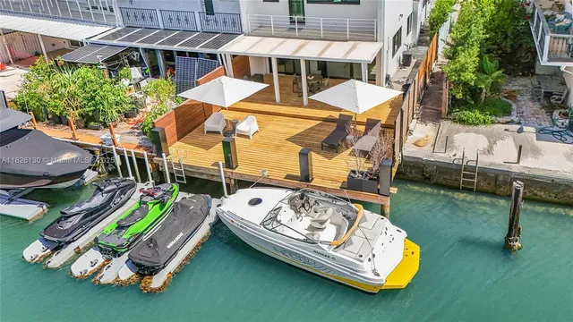 an aerial view of a house with swimming pool patio and outdoor seating
