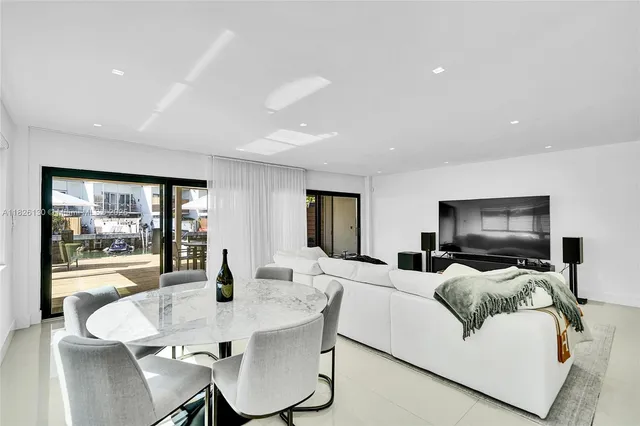 a kitchen with granite countertop a sink and white cabinets