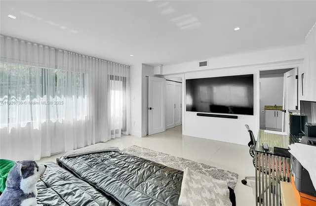 a bedroom with furniture and white walls