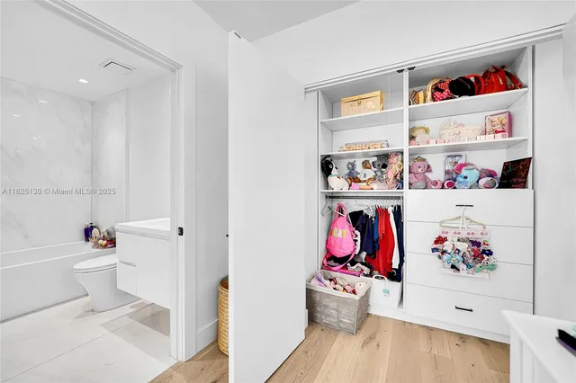 an aerial view of a city with lots of residential buildings lake and ocean view