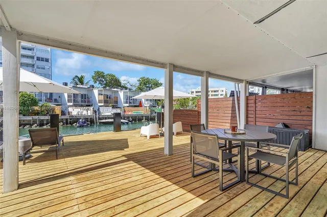 a dining room with furniture window and wooden floor