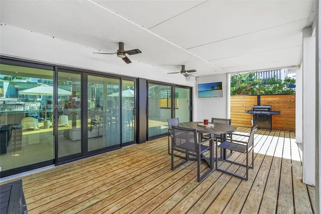 a view of a patio with couches table and chairs and potted plants