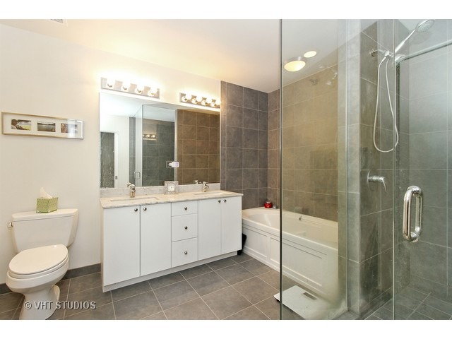 235 West Van Buren Street, Unit 4606 Chicago, IL 60607 - Photo 11 of 22 a bathroom with a sink a toilet and shower
