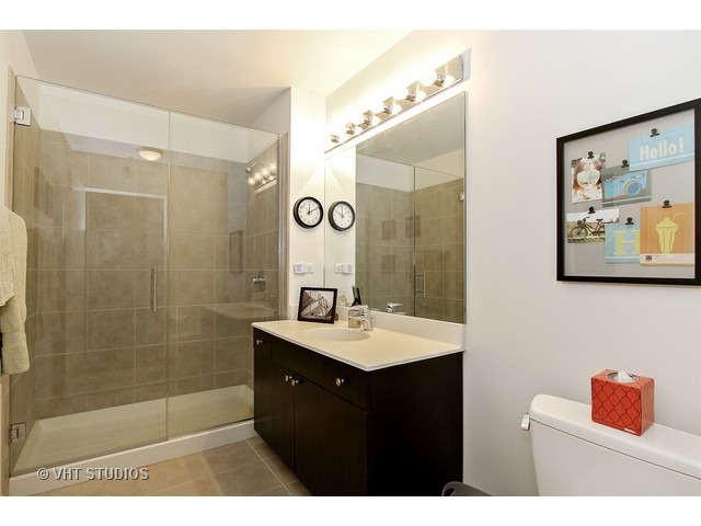235 West Van Buren Street, Unit 4606 Chicago, IL 60607 - Photo 13 of 22 a bathroom with a sink a shower a mirror and a sink