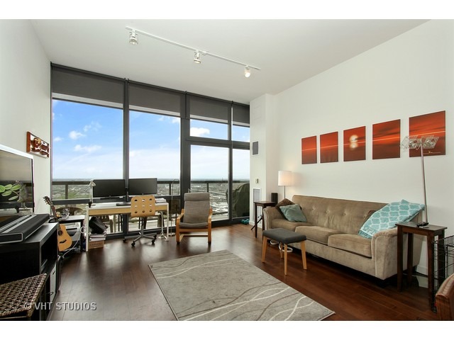 235 West Van Buren Street, Unit 4606 Chicago, IL 60607 - Photo 6 of 22 a living room with furniture and floor to ceiling window