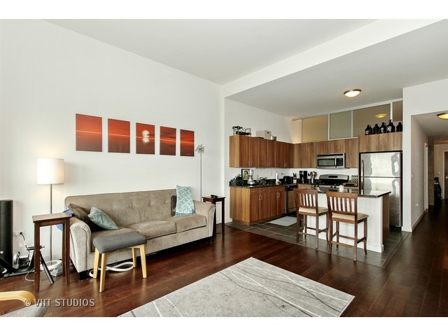 235 West Van Buren Street, Unit 4606 Chicago, IL 60607 - Photo 8 of 22 a living room with furniture and kitchen view