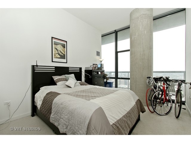 235 West Van Buren Street, Unit 4606 Chicago, IL 60607 - Photo 10 of 22 a bedroom with a bed and two windows