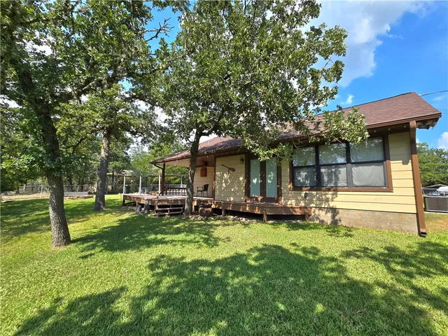 a view of a house with a yard porch and sitting area