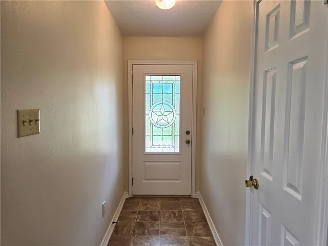 a view of a hallway with a window