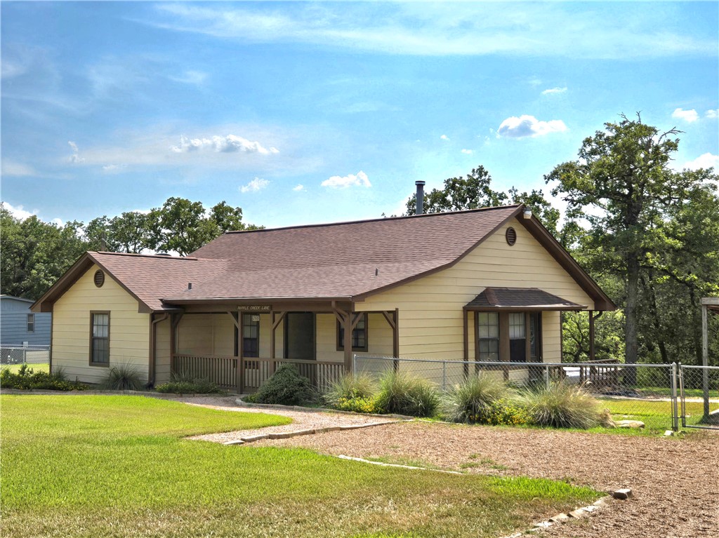 219 Ripple Creek Lane Somerville, TX 77879 - Photo 2 of 40 a front view of a house with a yard and potted plants