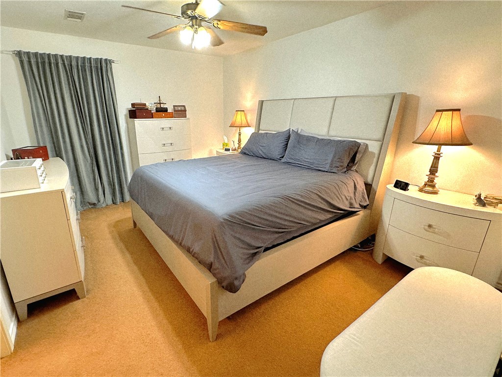 219 Ripple Creek Lane Somerville, TX 77879 - Photo 22 of 40 a bedroom with a bed and a chandelier