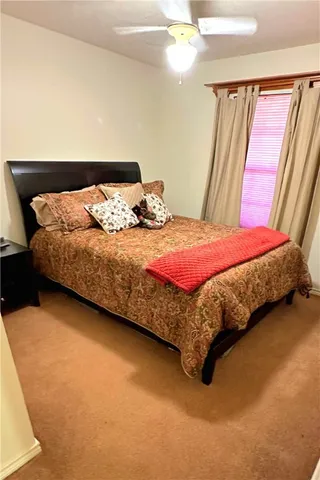 a bedroom with a bed and lamp with window