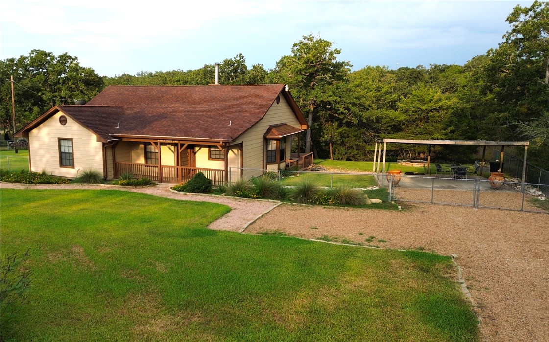 219 Ripple Creek Lane Somerville, TX 77879 - Photo 35 of 40 a front view of a house with a yard and trees