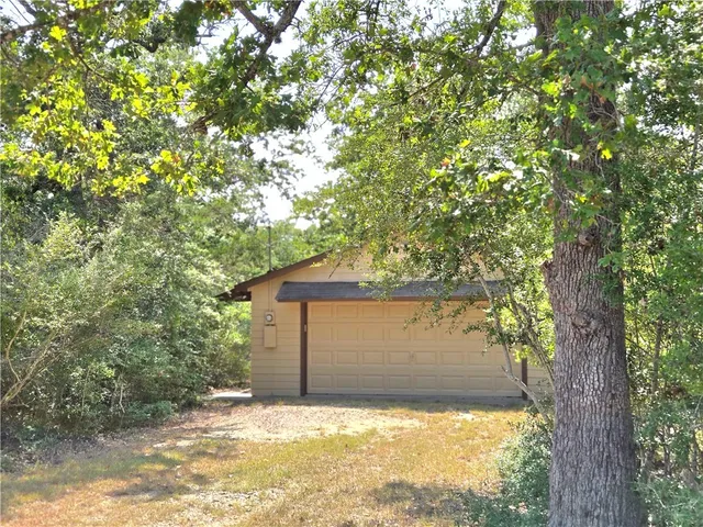 a view of a house with a tree