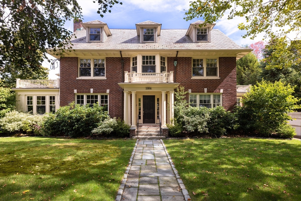 a front view of a house with garden