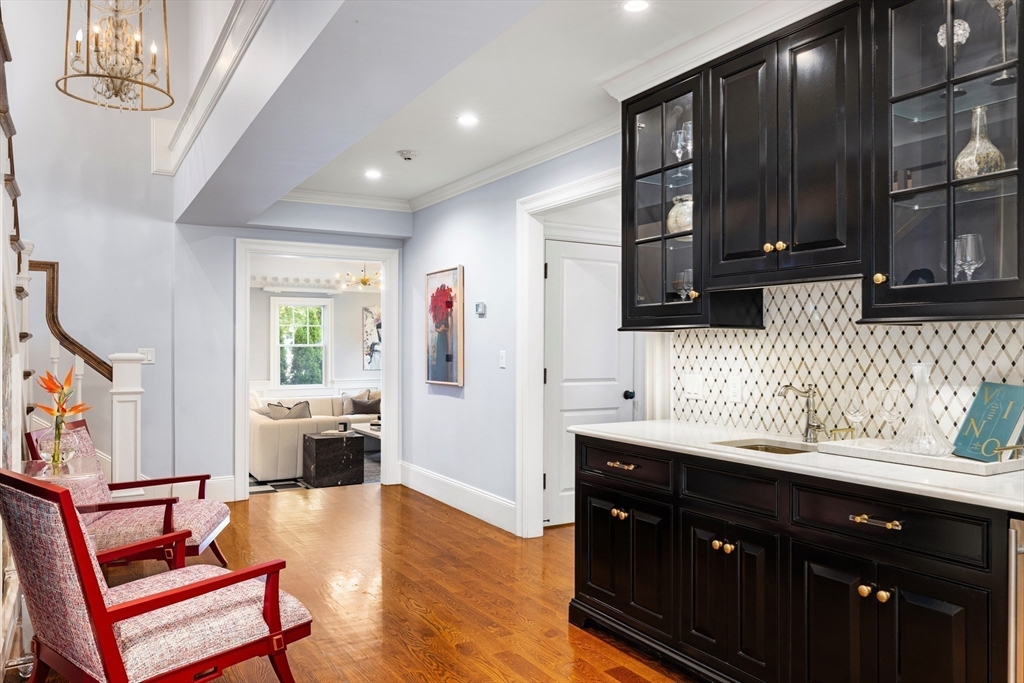 1004 Centre Street Newton, MA 02459 - Photo 15 of 34 a kitchen with stainless steel appliances granite countertop a sink dishwasher stove and wooden cabinets with wooden floor