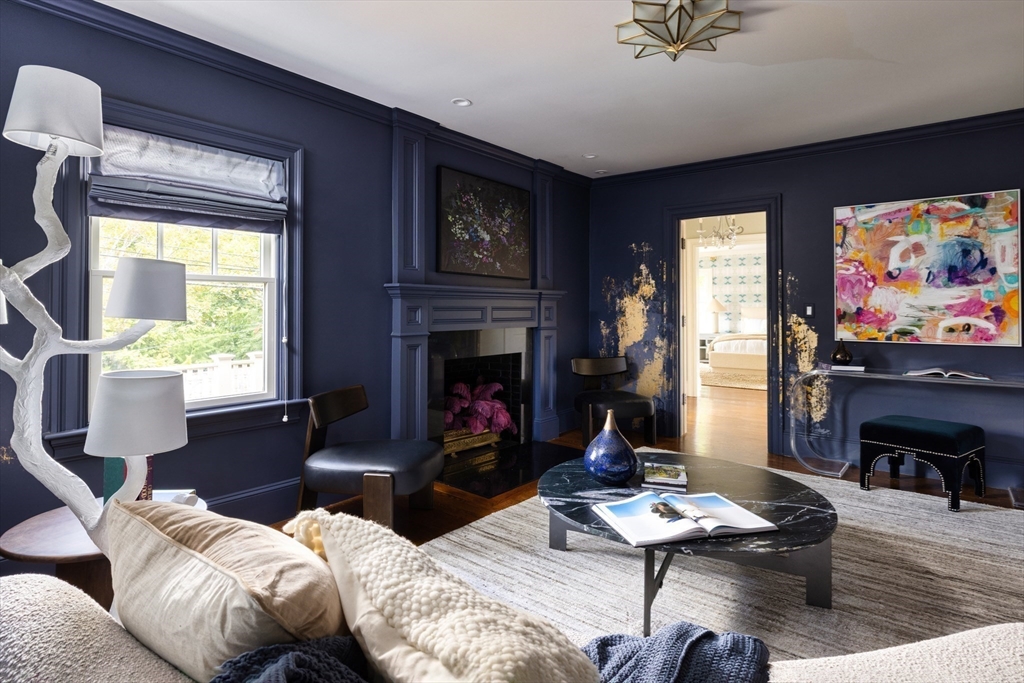 1004 Centre Street Newton, MA 02459 - Photo 19 of 34 a living room with furniture a fireplace and a flat screen tv