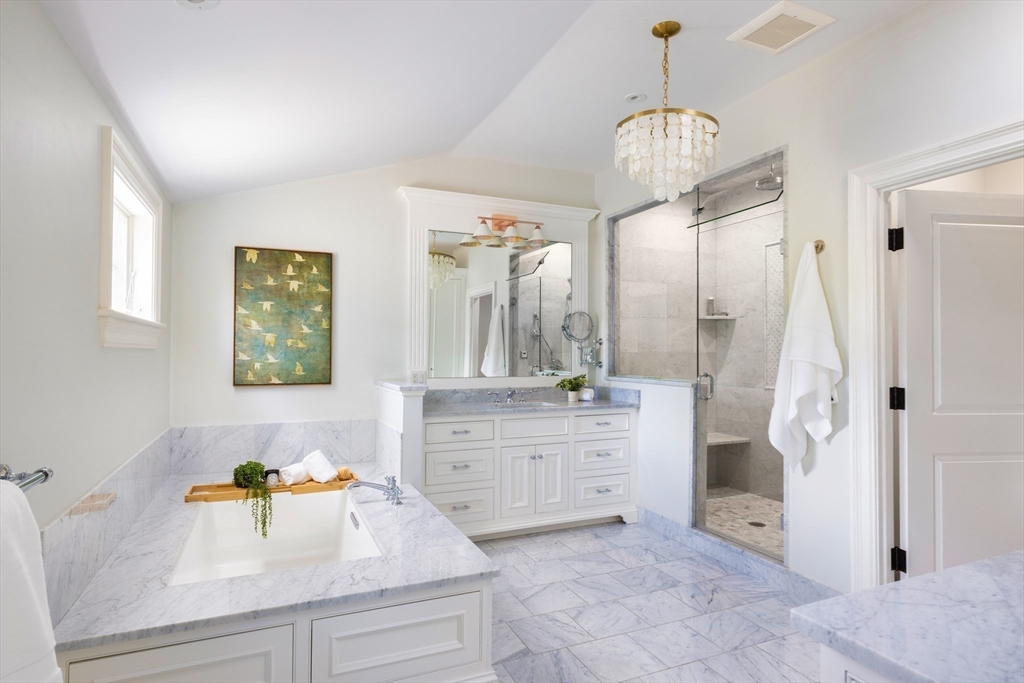 1004 Centre Street Newton, MA 02459 - Photo 21 of 34 a spacious bathroom with a granite countertop sink a mirror and a shower