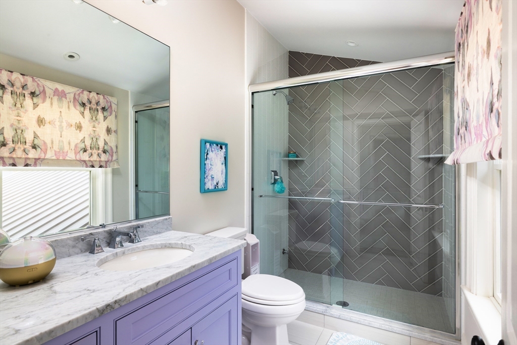 1004 Centre Street Newton, MA 02459 - Photo 23 of 34 a bathroom with a granite countertop sink toilet and shower