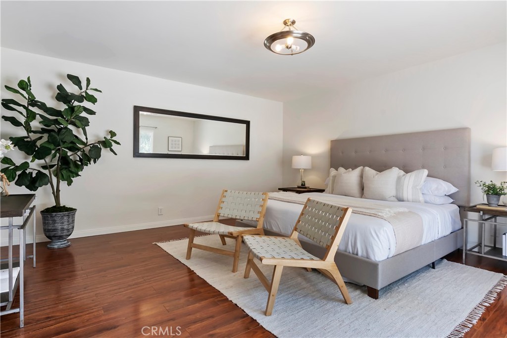 16828 Margate Street Encino, CA 91436 - Photo 11 of 21 a bedroom with bed and a potted plant