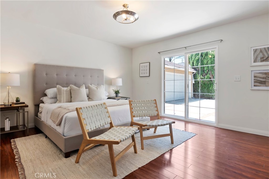 16828 Margate Street Encino, CA 91436 - Photo 12 of 21 a spacious bedroom with a bed and wooden floor