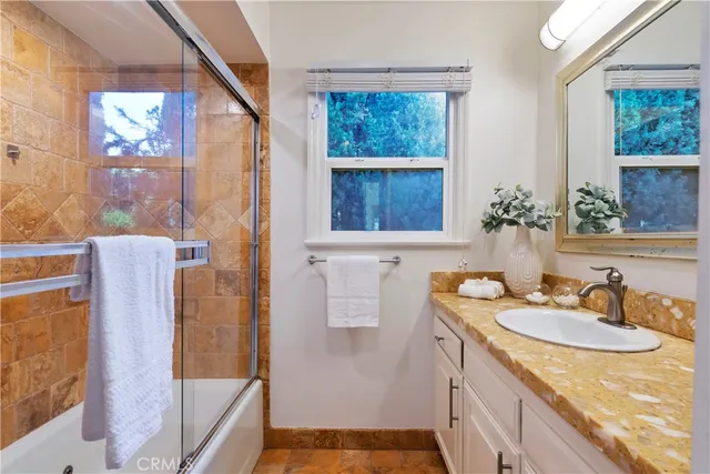 a bathroom with a sink a mirror and a shower