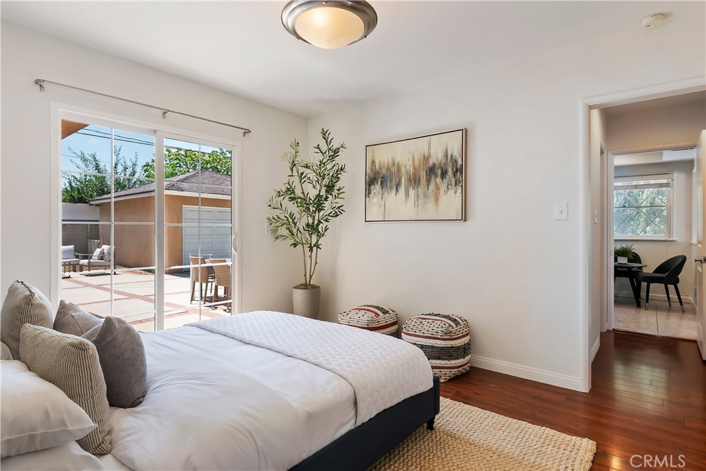 16828 Margate Street Encino, CA 91436 - Photo 16 of 21 a bedroom with a bed and wooden floor